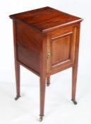 An Edwardian mahogany pot cupboard, the door with boxwood inlay, raised on square tapering legs