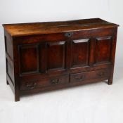 A George III oak mule chest, the twin plank top above four panels and two frieze drawers with