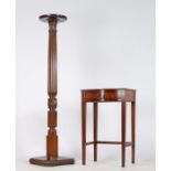 An Edwardian mahogany torchere stand, with dished circular top above a reeded an acanthus leaf