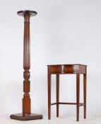 An Edwardian mahogany torchere stand, with dished circular top above a reeded an acanthus leaf