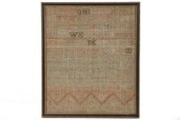 A 19th century needlework sampler, stitched with the alphabet, faded, housed in an ebonised and gilt