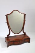 George III mahogany shield shaped toilet mirror, raised on a serpentine box base fitted three