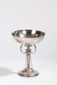 A George V silver golf trophy, with beaten bowl above a tapering stem surrounded by three vertical