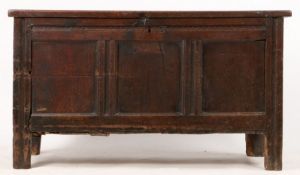 A 17th Century oak coffer, with triple panelled lid and front, the interior containing two later