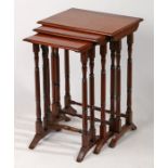 A nest of three 19th Century mahogany side tables, the chamfered tops above turned legs and