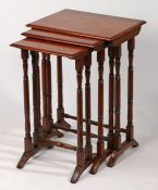 A nest of three 19th Century mahogany side tables, the chamfered tops above turned legs and
