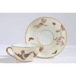 A Fischer & Mieg porcelain tea cup and saucer, finely painted with butterflies and insects on a