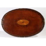 A Victorian mahogany and marquetry inlaid oval tray, with central oval fan inlay, wavy rim and brass