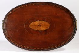 A Victorian mahogany and marquetry inlaid oval tray, with central oval fan inlay, wavy rim and brass