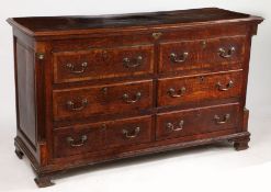 A George III oak mule chest, Lancashire, the hinged lid opening to reveal a candle box and small