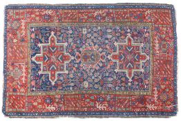 A Caucasian Kuba style rug, with a red blue and olive green ground, set with a two star guls with
