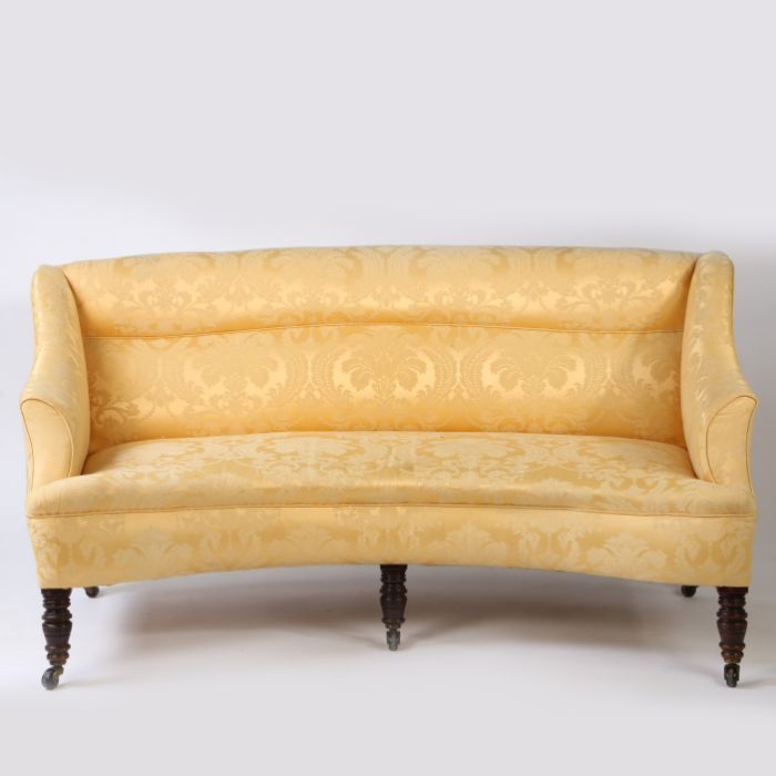A Pair of Victorian curved settees, each with yellow floral upholstery, the curved seats each raised