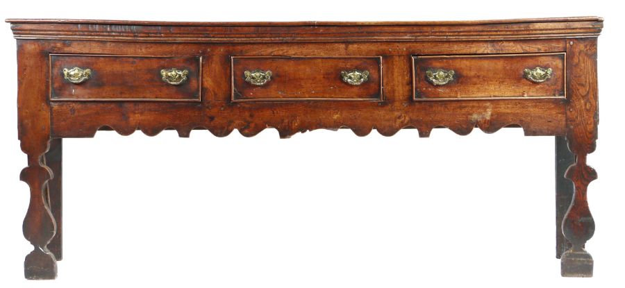 A George I oak and elm low dresser, circa 1720 Having a boarded top with applied moulded under-edge,