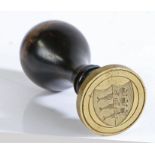A mid to late 19th Century desk seal, the ebonised wood handle of flat-topped inverted baluster form