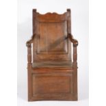 An oak and walnut box-seat open armchair, circa 1700 Having a fielded and moulded plain back