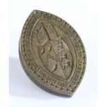 A brass seal matrix, of navette form, the central field engraved with a coat of arms and inscribed