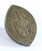 A brass seal matrix, of navette form, the central field engraved with a coat of arms and inscribed