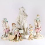 A group of 5 continental porcelain figurines including two candlesticks one probably by Meissen
