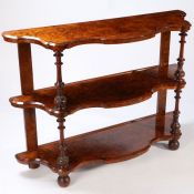 A Good 19th century figured walnut serpentine three tier whatnot, having turned supports with