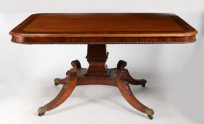 A Regency mahogany tilt top breakfast table, having a rectangular top inlaid with rosewood cross