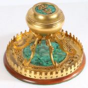 A Regency gilt metal and malachite inkwell, the ovoid well section with circular malachite inset lid