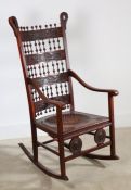 A late 19th century rocking chair in the Moorish style with a pair medallion heads to front rail,