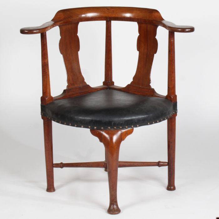 A George III mahogany corner chair, with a curved cresting above turned tapering supports and two