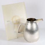 Gerald Benney, an Elizabeth II silver water jug, London 1973, bulbous body with a textured finish