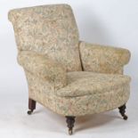 In the manner of Howard & Sons a deep seated armchair, having a scroll back upholstered in a