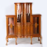 An Edwardian mahogany inlaid and glazed serpentine display cabinet, having six doors raised on