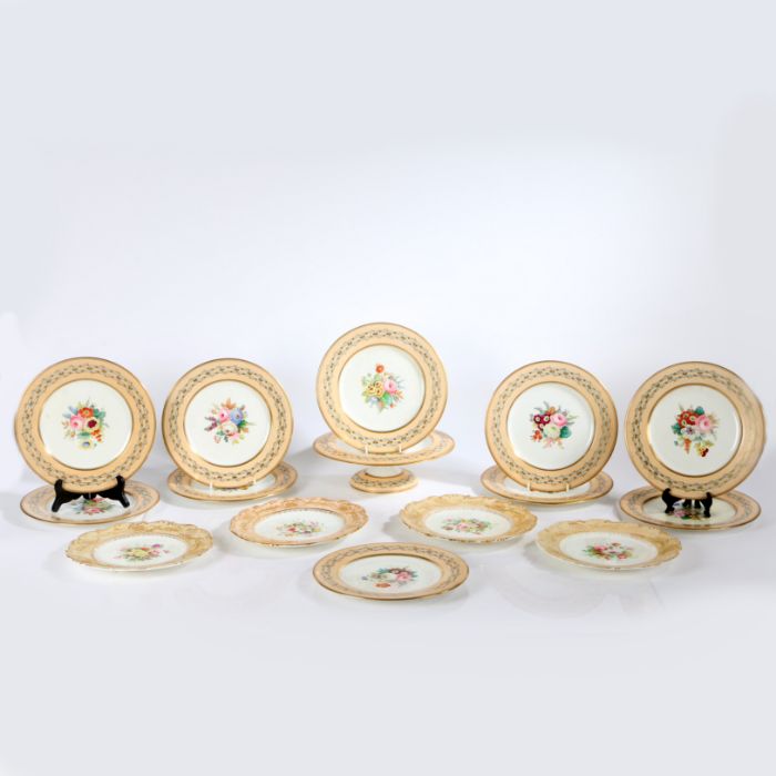 A set of 4 Coalport rococo edged dessert plates with hand painted flowers to center possibly by