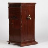 A 19th century mahogany butlers pedestal cupboard, having a square top with a reeded frieze