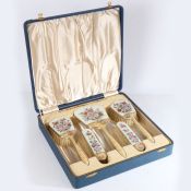 A cased silver and enamel dressing set comprising four clothes brushes and hand mirror, Birmingham