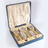 A cased silver and enamel dressing set comprising four clothes brushes and hand mirror, Birmingham