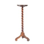 A 17th century walnut candlestand, circa 1690 and later Having a circular dished top, on a spiral-