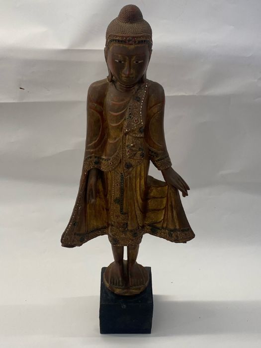 A 20th century gilt and lacquered carved Burmese standing Buddha