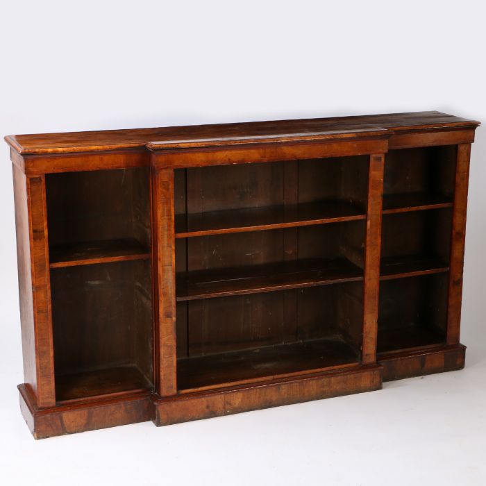 A 19th century figured walnut breakfront bookcase, having a cross banded and boxwood inlaid front