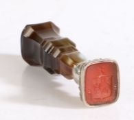 A late 19th Century hardstone and white metal desk seal, the mottled brown chamfered agate handle