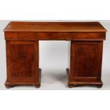 A George III yew wood pedestal desk, the four plank rectangular top above three drawers and two