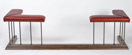 A 20th century oak and leather club fender, having a red leather padded top with studding above