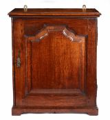 A George II oak table-top spice cupboard, circa 1750 and later Having a flattened-ogee arched