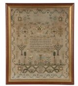 An embroidered sampler by Elizabeth Daplyn aged 9, dated 1825 with a religious verse, motifs of