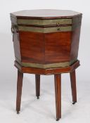 A George III mahogany and brass bound cellarette of octagonal form, having twin carrying handles