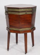 A George III mahogany and brass bound cellarette of octagonal form, having twin carrying handles