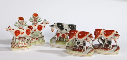 A pair of 19th century Staffordshire spill vases modelled as a cow with calf, 18cm height and