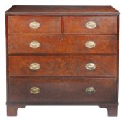 A George III well-figured solid burr-elm chest of drawers, circa 1800 Having an impressive single-