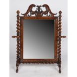 A Victorian rosewood swing frame mirror, having a ornately scroll carved frieze above a