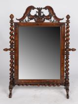 A Victorian rosewood swing frame mirror, having a ornately scroll carved frieze above a