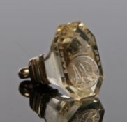A 19th century yellow metal and glass fob seal, depicting monogrammed initials and a arm holding a