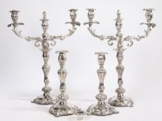 A post-Regency Old Sheffield Plate four-piece table lighting suite, comprising of a pair of three-